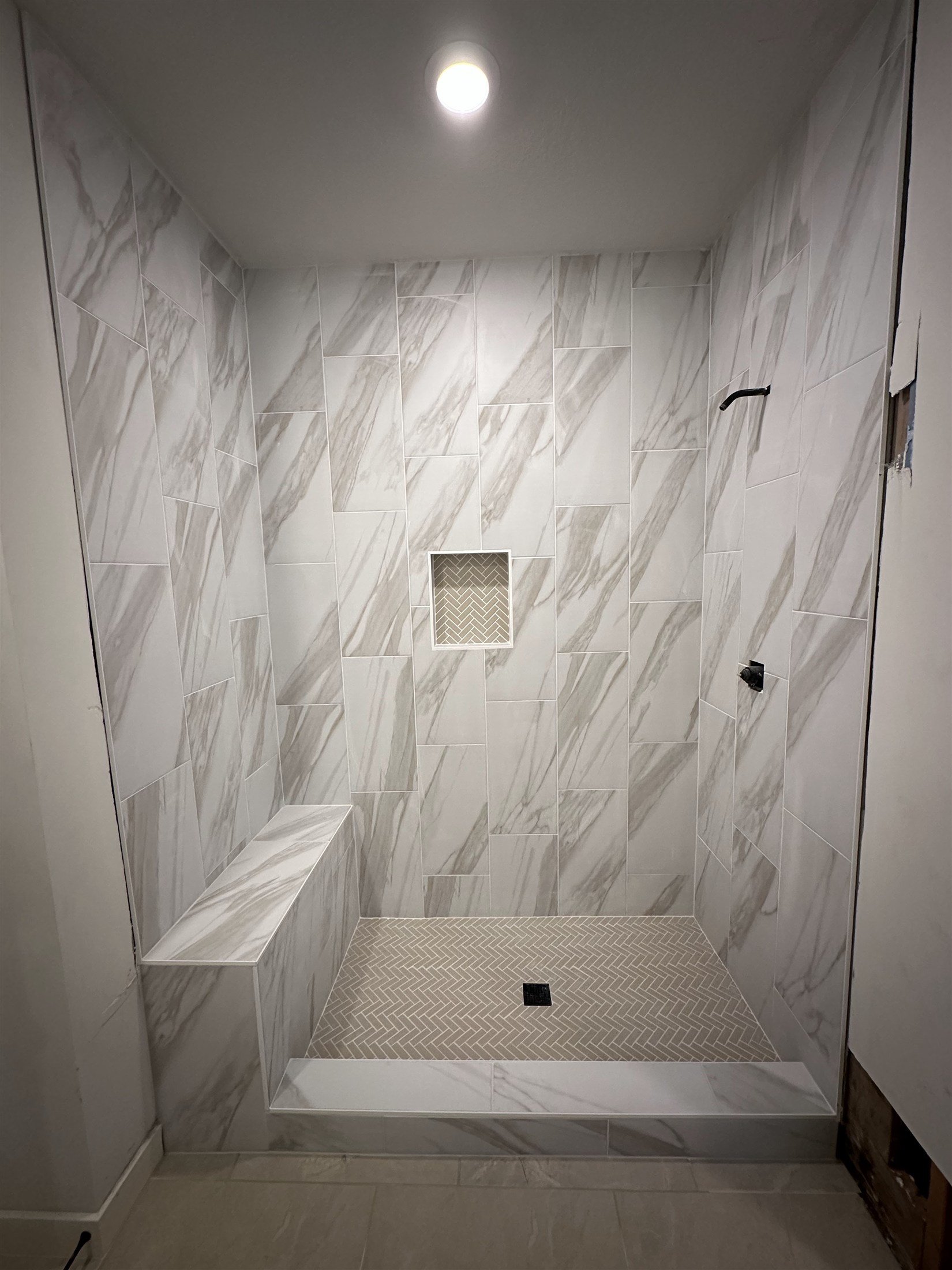Marble-look shower walls installed by Heartland Tile