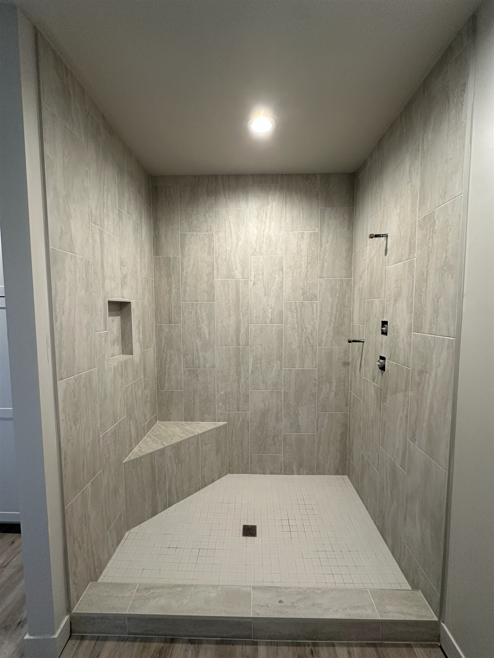 Clean lines & recessed niche installed by Heartland Tile